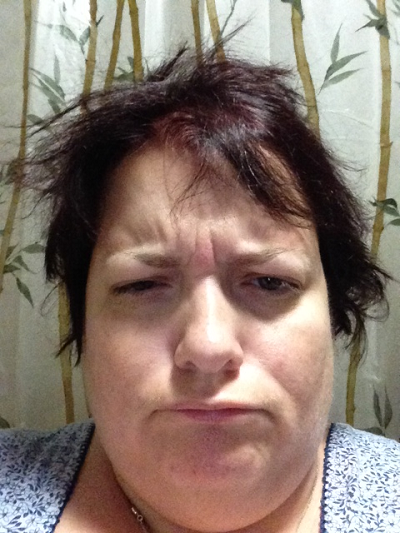 Michelle with bedhead and a scowl on her face