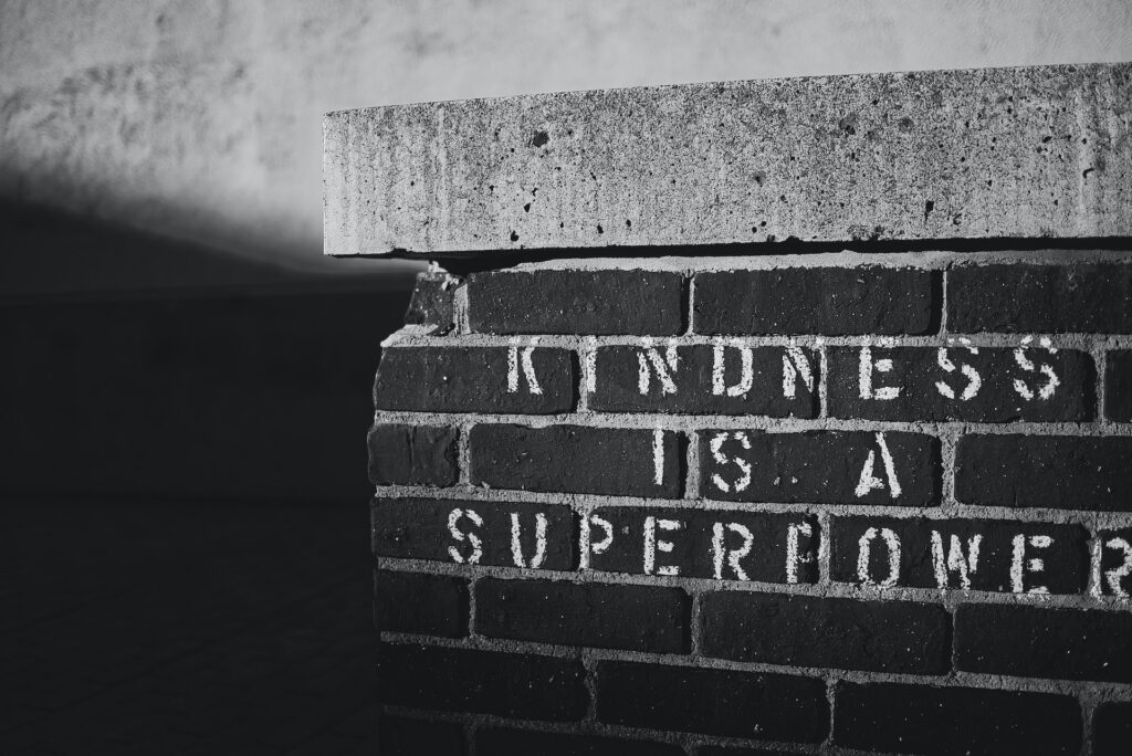 A brick wall on which is written "Kindness is a superpower"