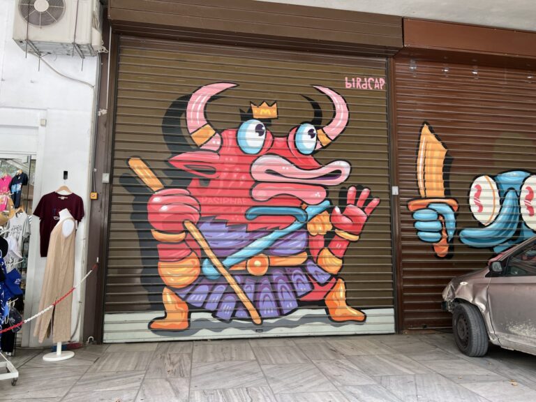 Graffiti of a strange creature on a garage door.