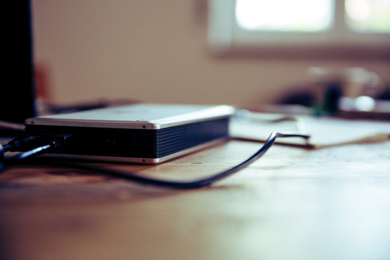 an external hard drive beside a laptop computer