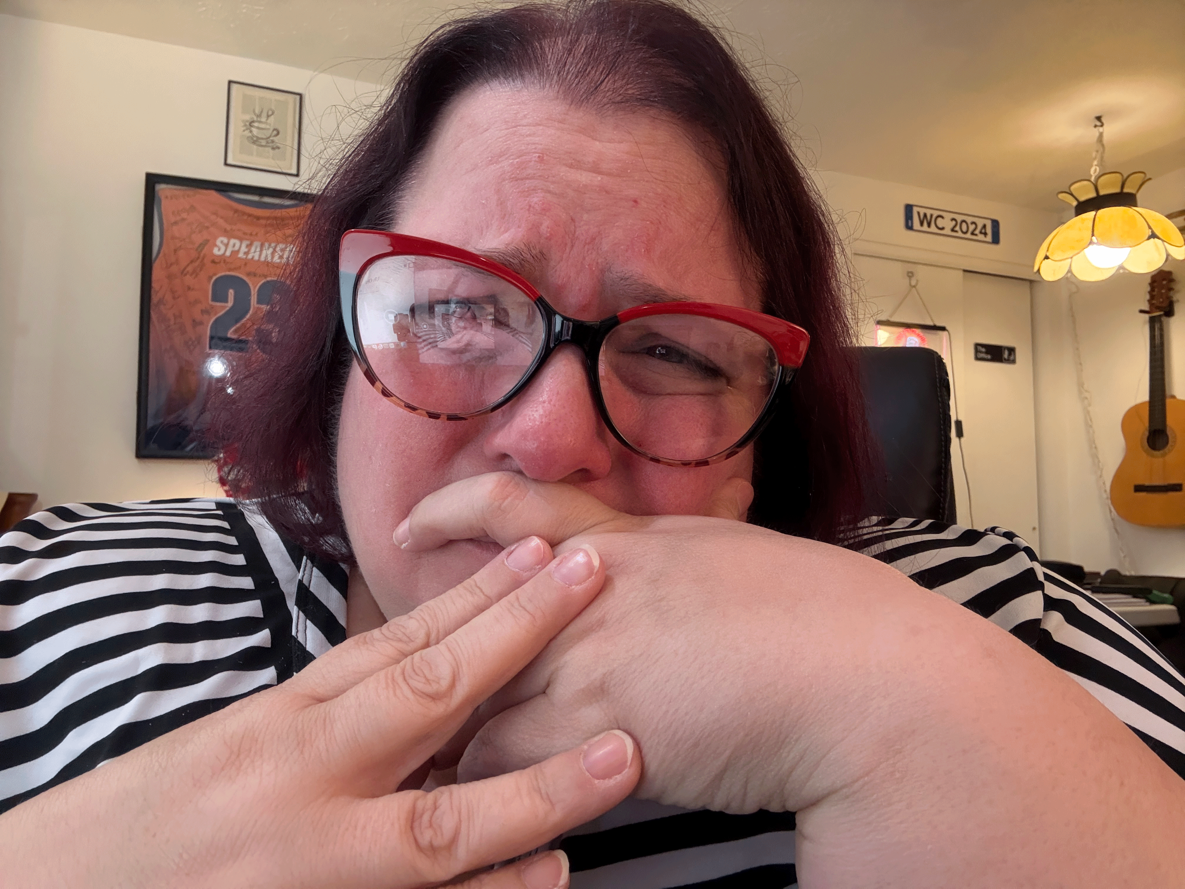 An animated GIF of Michelle making faces of various stages of angst including crying and covering her face with her hands.